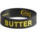 A black rubber wristband with yellow text that says "Butter"