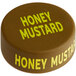 A brown circular silicone lid with yellow text that reads "Honey Mustard"