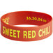 A red silicone band with yellow text that says "Sweet Red Chili" on a counter.