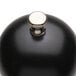 A black round object with a silver knob.