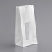 A white paper bag with a window.
