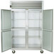 A Traulsen stainless steel reach-in freezer with open left and right doors.