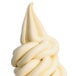 A white ice cream cone with a white soft serve swirl using the Carpigiani Flower Nozzle.