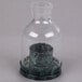 A Sterno clear glass lantern candle holder with a candle inside.