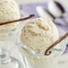 A scoop of Nielsen-Massey Gourmet Vanilla Beans ice cream in a glass bowl.