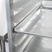 A Cres Cor sheet pan rack with trays on it.
