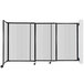 A clear poly wall-mounted room divider with black metal sliding bar.