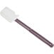 A grey silicone spatula with a white handle.