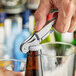 A hand using an Acopa waiter's corkscrew to open a bottle.