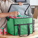 A man putting a can into a green Choice insulated cooler bag.