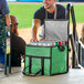 A man opening a Choice green medium insulated cooler bag filled with cans of beer.