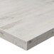 A white rectangular BFM Seating table top with a wooden edge.