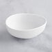 A white GET Enterprises Riverstone small melamine bowl.