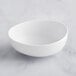 A white GET Enterprises Riverstone melamine bowl on a white surface.