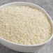 A bowl of Goya Thai white jasmine rice on a table.