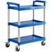 A blue utility cart with three shelves and wheels.