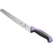 A Mercer Culinary Millennia Colors bread knife with a purple handle and black blade.