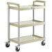 A beige plastic three-tiered cart with wheels.