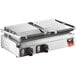 A Vollrath double Panini grill with two cast iron presses on a counter.
