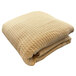 A beige Jaipur thermal honeycomb blanket with a tan pattern.
