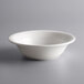 A Tuxton Concentrix white china pasta/salad bowl on a gray surface.