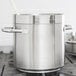 A close-up of a large silver Vollrath stainless steel stock pot.