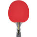 A red Stiga Raptor table tennis paddle with a black and yellow handle.