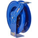 A blue metal Coxreels hose reel with a yellow label.