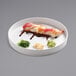 A Cal-Mil white melamine plate with sushi and sauce on it.