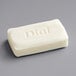 A white Dial bar soap on a gray surface.
