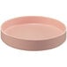 A pink round Cal-Mil melamine plate with a raised rim.