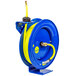 A blue and yellow Coxreels hose reel with a blue hose attached.