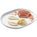A white Cal-Mil melamine platter with sauces and slices of meat on it.