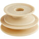 A close-up of a beige plastic circular pulley with a hole in the center.