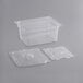 A clear plastic Vigor 1/2 size food pan with a clear lid and tray.