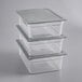 A stack of three clear plastic Vigor food pans with clear plastic lids.