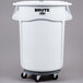 A white plastic Rubbermaid BRUTE ingredient storage bin with wheels and a lid.