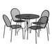 A black Lancaster Table & Seating Harbor table with ornate legs and 4 chairs on an outdoor patio.