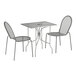 A Lancaster Table & Seating Harbor Gray rectangular outdoor table with ornate legs and 2 chairs.