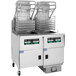 A Pitco Solstice natural gas rack floor fryer with baskets on wheels.