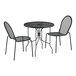 A Lancaster Table & Seating black metal outdoor bistro set with ornate legs on a table with two chairs.