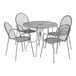 A Lancaster Table & Seating Harbor Gray round outdoor table with ornate legs and four arm chairs.