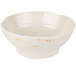 A white bowl with orange spots on a white surface.