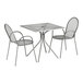 A Lancaster Table & Seating outdoor table and two arm chairs with modern legs on a patio.
