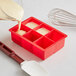 A red Choice silicone ice mold with 6 cubes.