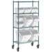 A Baker's Mark three tier white epoxy shelving unit with white plastic bins and clear lids on a green metal shelf.