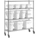A metal shelving unit with three white Baker's Mark ingredient bins.