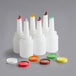 A group of white Choice pour bottles with colorful caps.