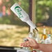 A man practicing bartending with a Choice 12" Bartending Flair Bottle.