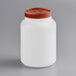 A white jar with a brown lid.